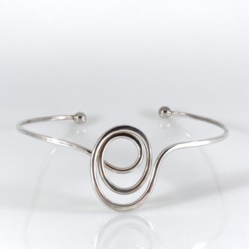 Neckring by Anna Greta Eker for PLUS, single piece of silver entwining the neck, twirling into a delicate knot at the front. MCM form one of the best.