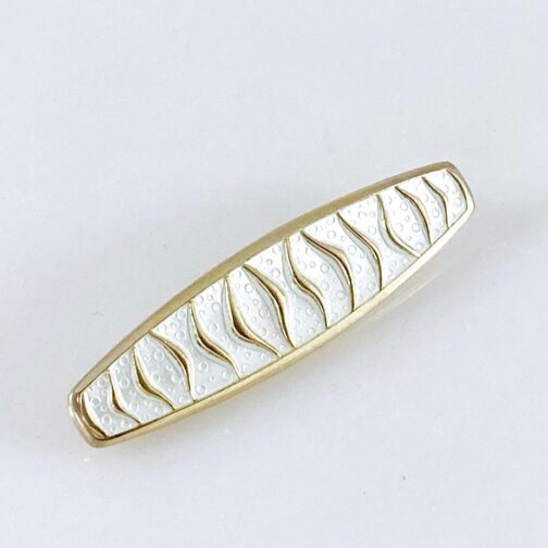 Brooch by Agnar Skrede for David-Andersen. The design is named "Wave", silver gilt with white enamel and typical of Scandinavian Mid Century Modern Jewelry.