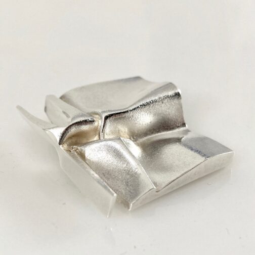 Björn Weckström brooch "Sculptor". Made to the "Space jewelry" series for Lapponia in the 1970ies. The piece shows the softness of the silver in what resembles the Japanese art of paper folding.