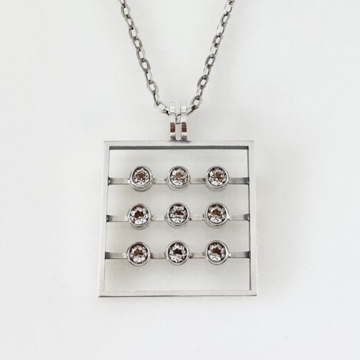 Pendant by Elis Kauppi. Discover this exquisite work for Kupittaan Kulta. A legendary Mid Century Modern Jewelry piece featuring a geometric design in silver adorned with rock crystals.