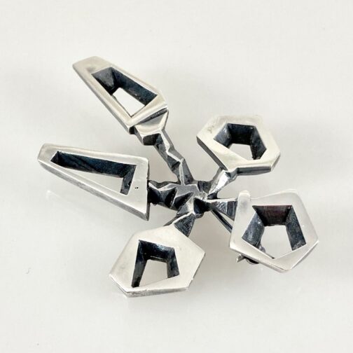 Modernist brooch by Gudmund Elvestad for J. Tostrup. Brutal yet delicately executed, focusing on the contrast between clean surfaces and a mechanical look.