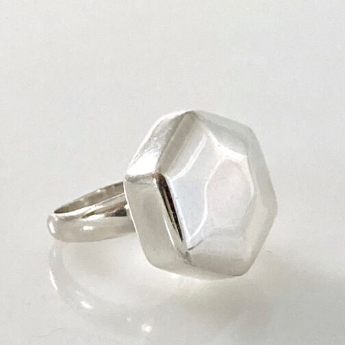 Ring by Georg Jensen. Made in slver, in a hexagonal form, smooth and soft, yet clearly defined. Danish Mid Century Modern Jewelry from one of the masters.