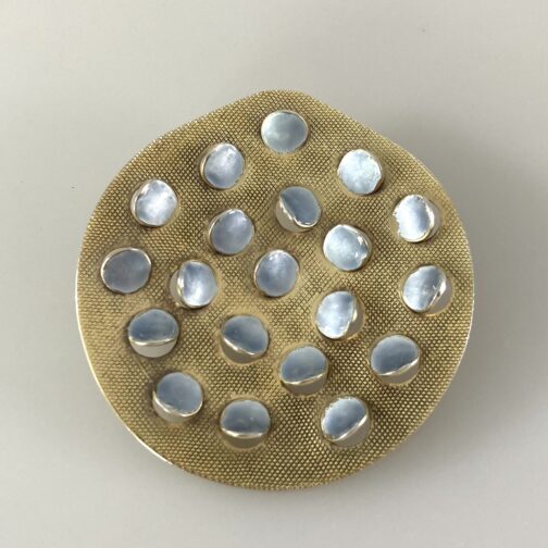 White/gray enamel brooch With Points by Grete Prytz Kittelsen; one of her loved designs. A play with shapes, light and darkness; silver gilt with enamel.
