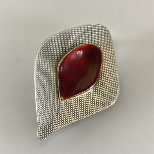 Silver red enamel brooch by Grete Prytz Kittelsen for Tostrup, in her "With Points" series. Scandinavian Mid Century Modern Jewelry from a master.