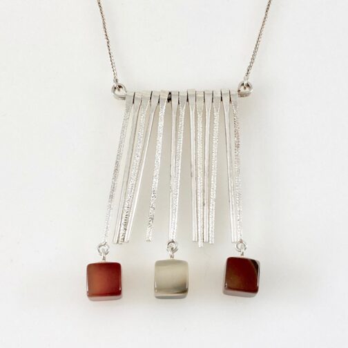 Pendant by Ivar Kvaale. Kinetic piece in silver with cut Agates in earthy colours.