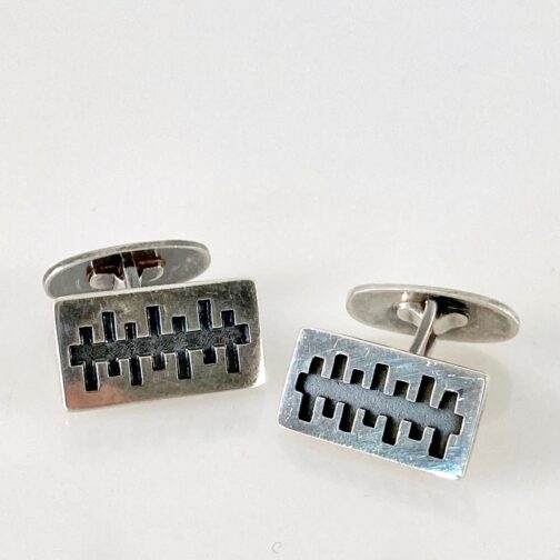 Cufflinks by Kaj Faale Larsen, made in partly oxidized silver. Faale uses a strict outer shape to present an experimental pattern created within. Norwegian MCM.