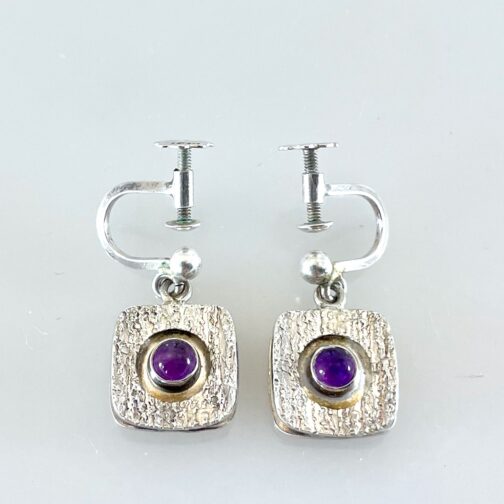 Earrings by Oscar Pärno for Opifors AB. Amazingly simple yet detailed work, the pieces created in partly oxidized silver with Amethysts set in the middle.