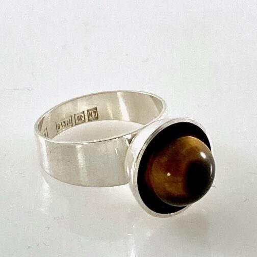 Ring by Turun Hopea, silver with Tiger's Eye. Experimental, progressve yet gentle design, smooth surfaces and brilliance of design. Finnish MCM Jewelry.