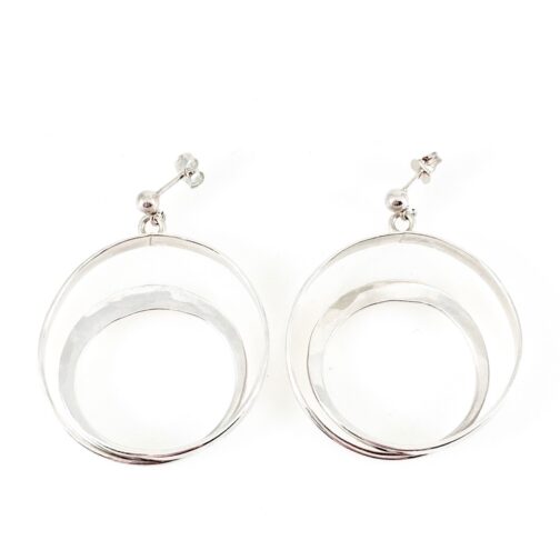 Tone Vigeland earrings for PLUS. Twirling pieces of silver making double circles in the design simply denoted H82 in the PLUS records. Surfaces delicately hammered.