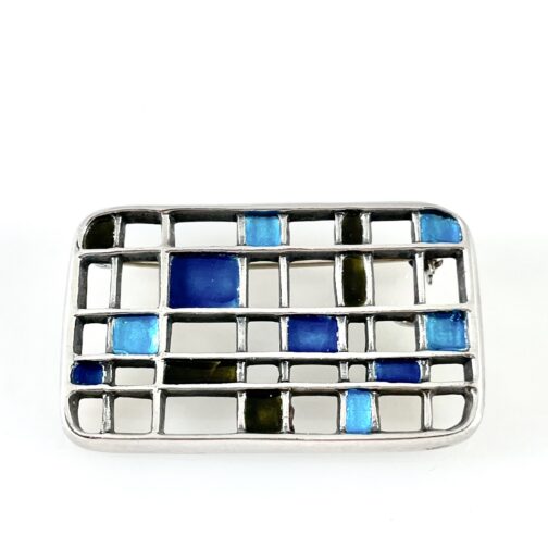 Brooch Pendant by Uni David-Andersen (studio). Set as a grid in silver, with a multi-couloured pattern of enamel.