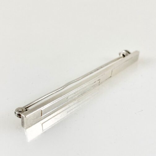 Silver brooch by Wiwen Nilsson, the Swedish master silversmith in the time moving from the Swedish Grace Era into the early Mid Century Modernism. Stringent simplicity with geometrich decoration.